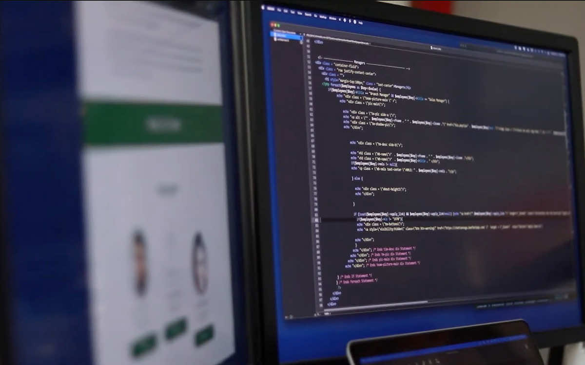 Website and app development project displayed on screens